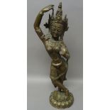 An Indian brass figure of Tara, standing in dancing pose on a lotus base, 54cm. high.