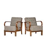 Kleinert; a pair of mid-20th century walnut framed reclining easy open armchairs on block supports,
