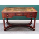 An Empire style gilt metal mounted mahogany writing desk, with three frieze drawers,