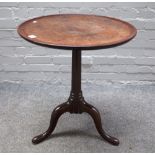 A mid-18th century mahogany occasional table, the dished circular one piece top on a tripod base,