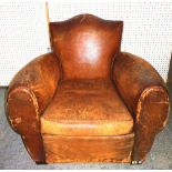 An early 20th century French club armchair with tan leather upholstery, 87cm wide.