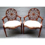 A pair of 20th century "spider web" back open armchairs on tapering square supports,