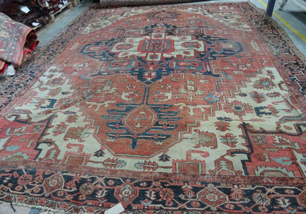 An Heriz carpet, Persian, the madder field with a bold angular pole medallion, ivory spandrels, - Image 3 of 23