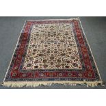 An Esfahan carpet, Persian, the ivory field with an allover palmette flowerhead and floral sprays,