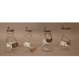 A collection of four silver mounted glass whisky noggins, in a variety of designs,