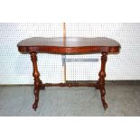 A Victorian walnut serpentine centre table on fluted bulbous supports, united by turned stretcher,