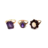 A 9ct gold ring, claw set with a cut cornered rectangular step cut amethyst, a gold,