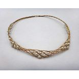 A gold and cultured pearl collar necklace, in an interwoven wirework design,