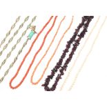 Two single row necklaces of coral beads, a single row necklace of tumbled garnet beads,