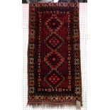 An Afghan rug, 140cm x 71cm.