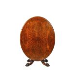 A Victorian framed walnut loo table, the oval snap top on four carved scroll supports,