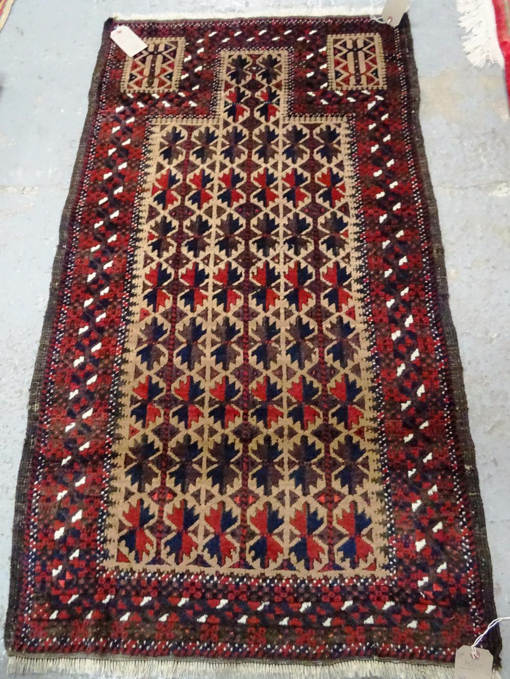 A Beluchistan prayer rug, the pale brown mehrab with matching three columns of flowering spandrels, - Image 3 of 4