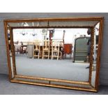 A 19th century gilt cushion framed rectangular mirror, with marginal border,