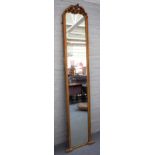 A late 19th century gilt framed robing mirror, with pierced, floral and acanthus crest,