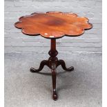 A mid-18th century style mahogany tripod supper table, with lobed circular top,