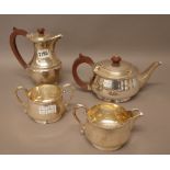 A silver four piece tea set, comprising; a teapot, a twin handled sugar bowl and a milk jug,