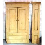 A 20th century pine corner unit with panelled doors, 130cm wide x 230cm high.