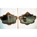 A pair of 20th century gilt framed mirrors with shell crests, 87cm wide x 70cm high.