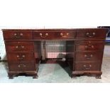 A 20th century mahogany pedestal desk with inset green leather top, 154cm wide x 80cm high.