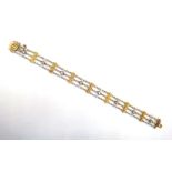 A gold two colour, diamond and seed pearl bracelet, circa 1910, in a three row design,