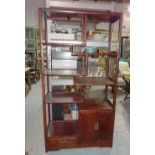 An early 20th century Chinese multi-tier shelf with single drawer and cupboard,