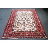 Isfahan carpet, Persian, the ivory field with all over palmette and floral sprays,