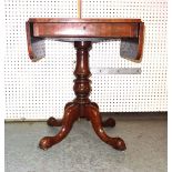 A Victorian rosewood drop flap work table on ring turned column and four downswept supports,