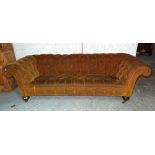 A Victorian button upholstered Chesterfield sofa on turned mahogany supports, 232cm wide.