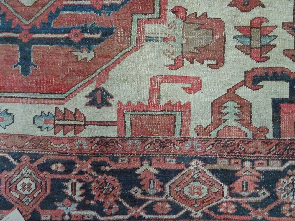 An Heriz carpet, Persian, the madder field with a bold angular pole medallion, ivory spandrels, - Image 7 of 23