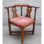 A George II mahogany corner chair with double pierced splat back on block supports,