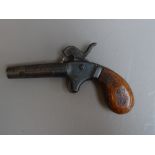 A 19th century percussion pocket pistol with twist off circular tapering steel barrel and two piece