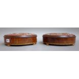 A pair of Victorian feather banded inlaid walnut oval foot stools,