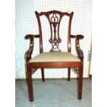 A 20th century Chippendale style mahogany open armchair on reeded supports.