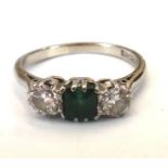 A white gold and platinum, emerald and diamond three stone ring,