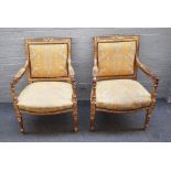 A pair of Louis XVI style gilt framed square back open armchairs on tapering fluted supports,