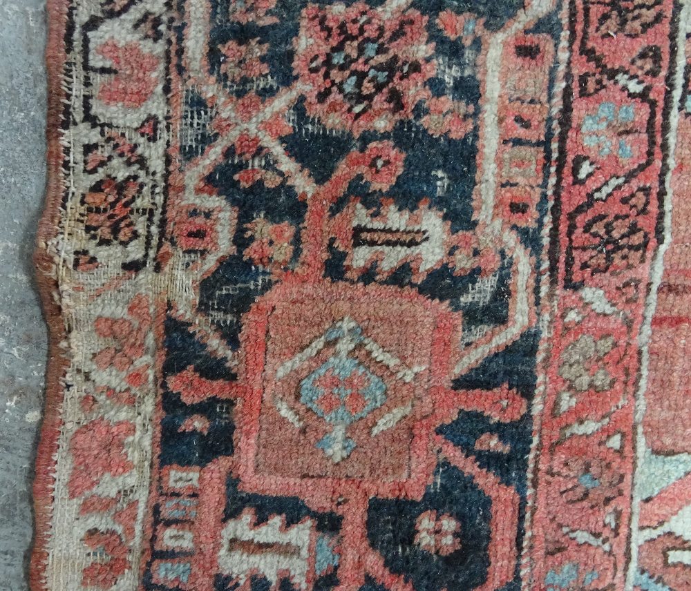 An Heriz carpet, Persian, the madder field with a bold angular pole medallion, ivory spandrels, - Image 9 of 23