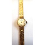 An Audax 9ct gold lady's bracelet wristwatch, the signed silvered dial with gilt baton numerals,