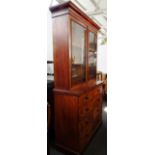 A Victorian mahogany bookcase chest, the pair of glazed doors over two banks of four short drawers,