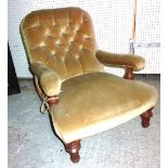 A late Victorian mahogany low open armchair on fluted tapering supports with brown upholstery.