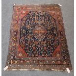 A Ghashgai rug, South Persian, the indigo field with a central medallion, madder spandrels,
