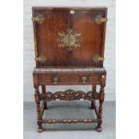 A mid-20th century carved oak two door drinks cabinet of Charles II design,