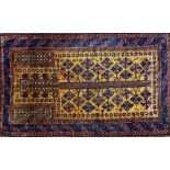 A Beluchistan prayer rug, the saffron mehrab with a flowering tree of life, plant spandrels,