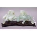 A Chinese green hardstone group, 20th century, carved as two Buddhist lions standing,