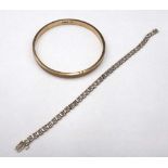 A 9ct gold and diamond set bracelet, claw set with a row of circular cut diamonds, on a snap clasp,