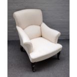 A Victorian easy armchair with outswept rollover arms on beehive turned supports,