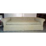 Nina Campbell, a 20th century three seater low sofa with rollover arms and grey upholstery,