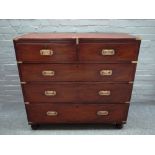 A campaign style brass bound hardwood chest of two short and three long drawers on turned feet,