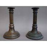 A matched pair of Victorian bronze candlesticks, each of turned form with 'V.R.
