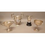 Silver, comprising; a twin handled trophy cup raised on a black composition stand,