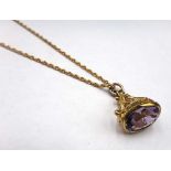 A 9ct gold and amethyst set single stone pendant fob, having ropetwist and wirework decoration,